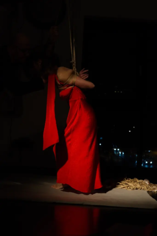 Visual representation of a Kinbaku Shibari Japanese Rope Bondage Performance by Alexander MA and Natasha NawaTaNeko in IKSK Berlin, Girl in red dress, sexpositive, conscious sexuality, couple