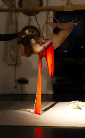 Visual representation of a Kinbaku Shibari Japanese Rope Bondage Performance by Alexander MA and Natasha NawaTaNeko in IKSK Berlin, Girl in red dress, sexpositive, conscious sexuality, couple