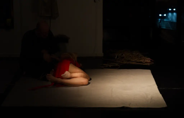 Visual representation of a Kinbaku Shibari Japanese Rope Bondage Performance by Alexander MA and Natasha NawaTaNeko in IKSK Berlin, Girl in red dress, sexpositive, conscious sexuality, couple