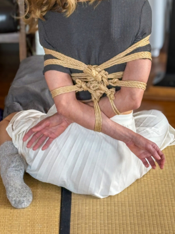 A man ties a woman, representation of sharing our approach to Gote (Box tie, Takate Kote) Shibari