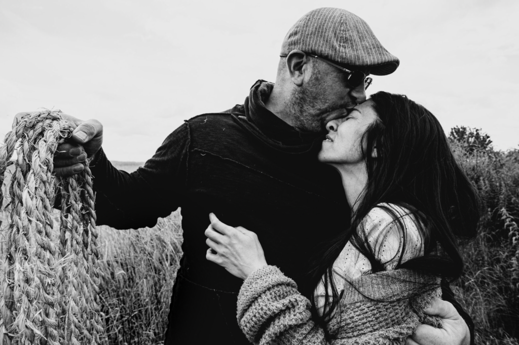 couple in the field man and woman intimacy hugging holding rice rope
