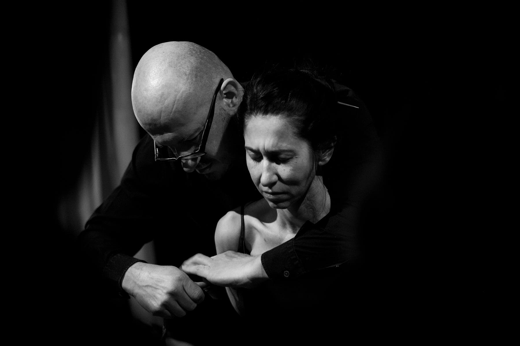 a man is tying a woman, great feeling of intimacy, couple closeness, black and white