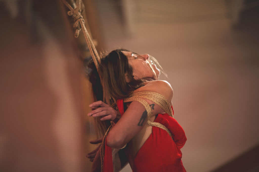 Rope bottom leaning backwards in an upper-body Kinbaku tie